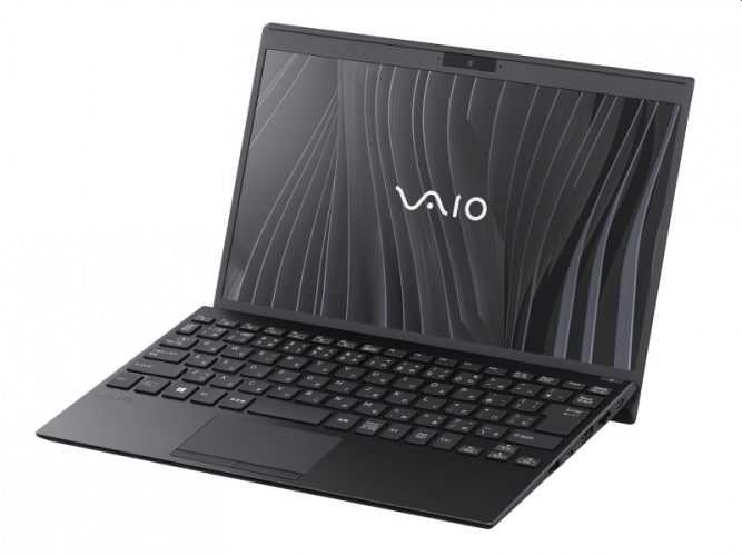 VAIO SX12 in Fine Black, lid open, showing a 12.5-inch screen with the VAIO logo on a dark wave wallpaper. JP keyboard layout.